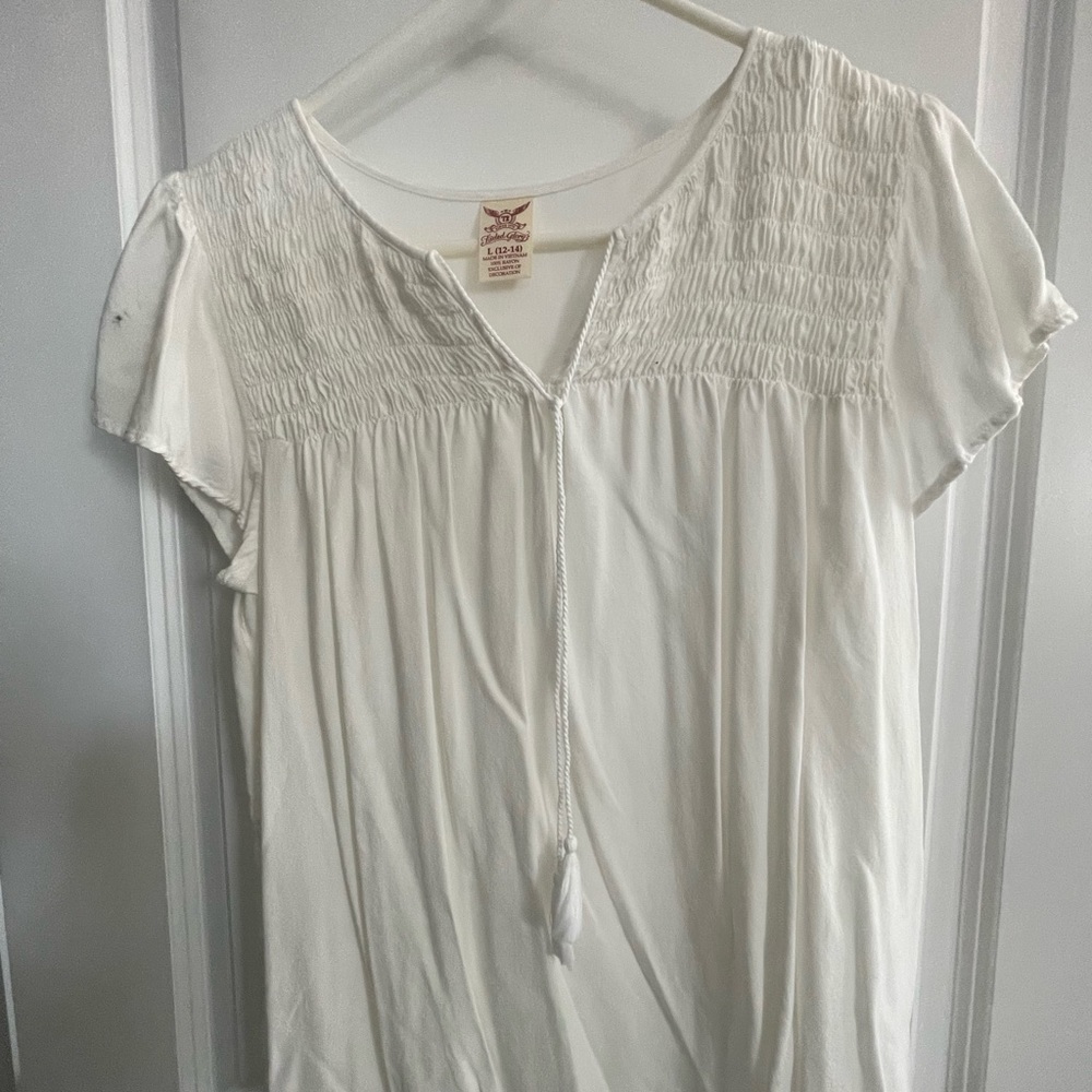 White blouse with tassel draw string, pretty front.